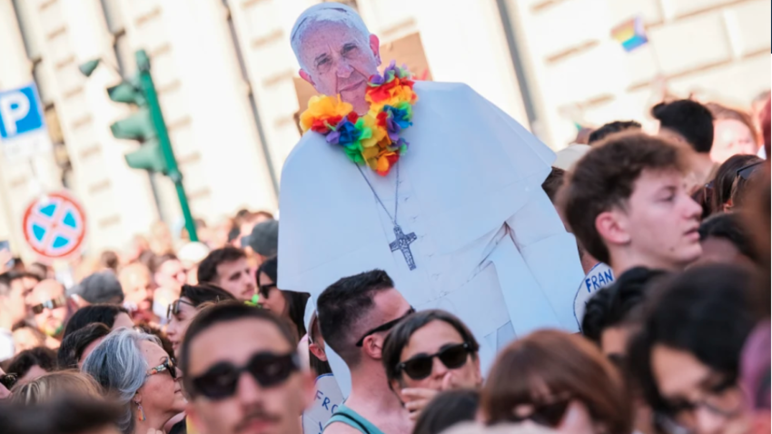 A cardboard silhouette of Pope Francis with a rainbow flower necklace during the 2024 Rome Pride march.