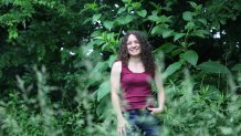 Amanda Beltramini Healan stands among the plants in her backyard in Nashville, Tenn., Monday, May 19, 2025, where she participates in No Mow Months to improve water retention and encourage pollinators. (AP Photo/Kristin M. Hall)