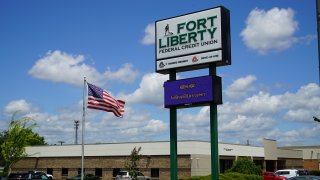 An American flag flaps in the breeze outside the Fort Liberty Federal Credit Union